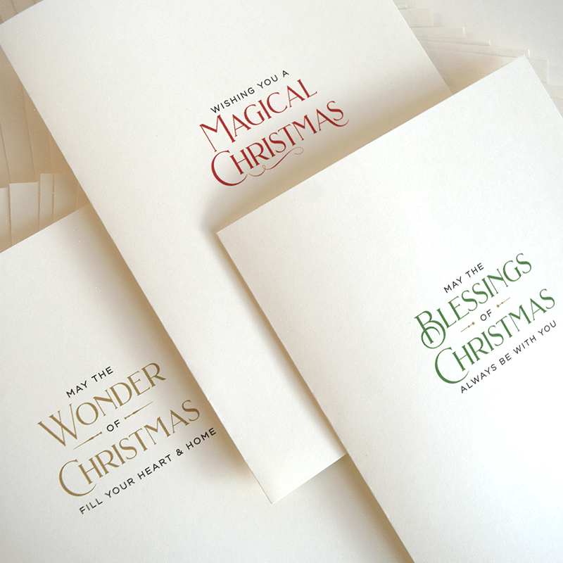 a pile of christmas cards sitting on top of each other.