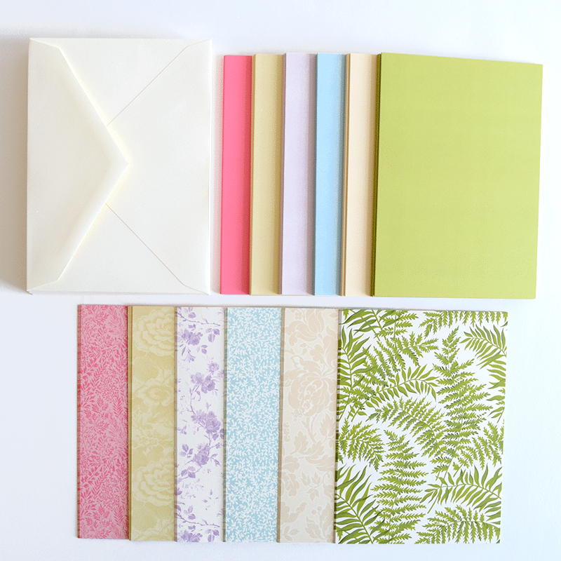a white table topped with lots of different colored papers.