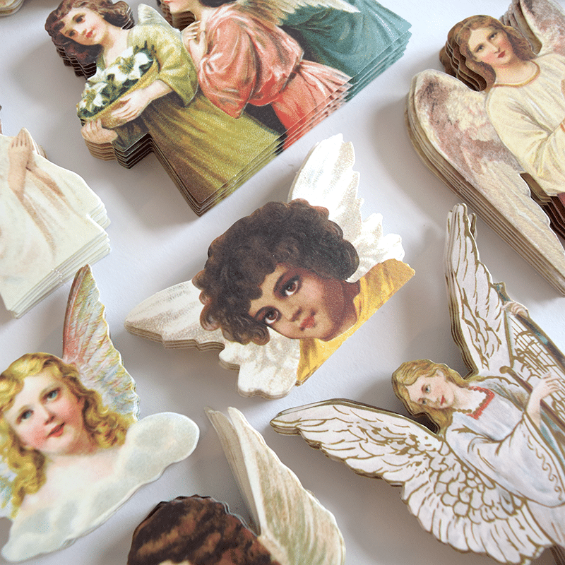 a bunch of angel magnets on a table.