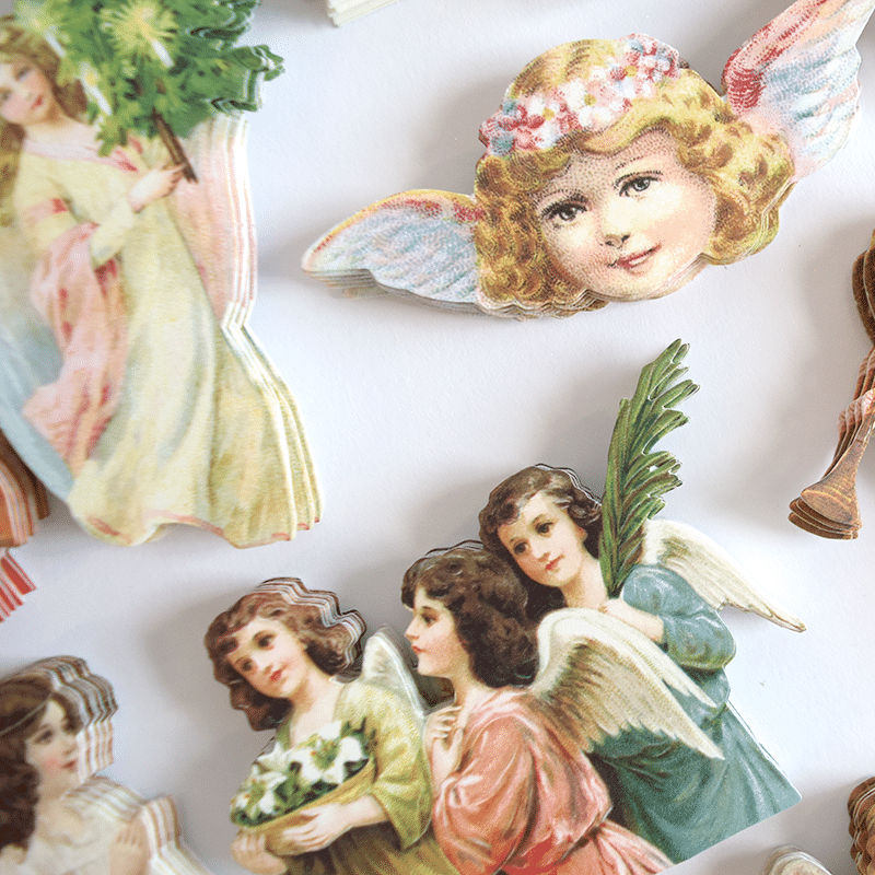 a bunch of angel pictures on a wall.