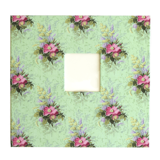 a picture frame with pink flowers on a green background.