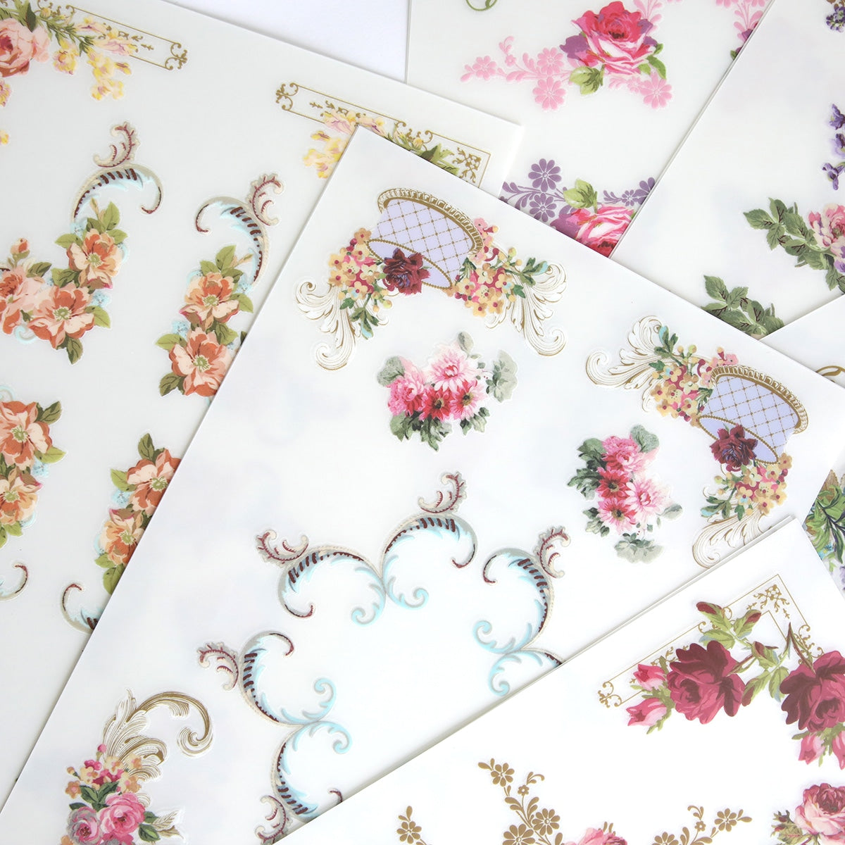 A variety of Birthday Ephemera Rub Ons designs are placed on a sheet of paper.