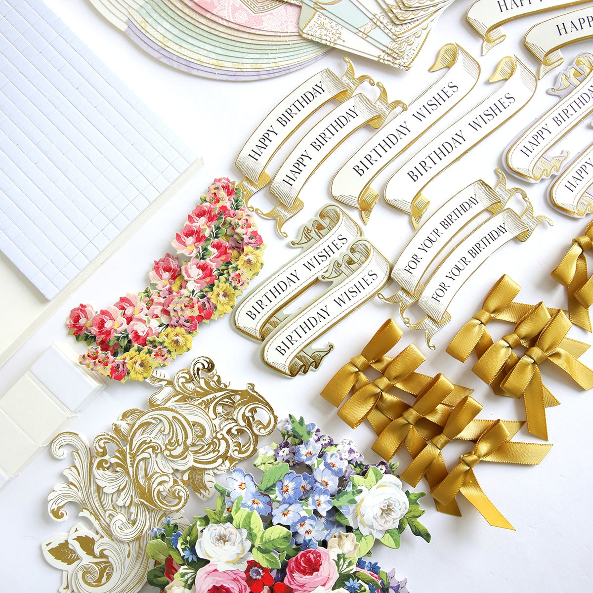 A bunch of paper flowers and a Simply Rocking Birthday Card Kit on a table.