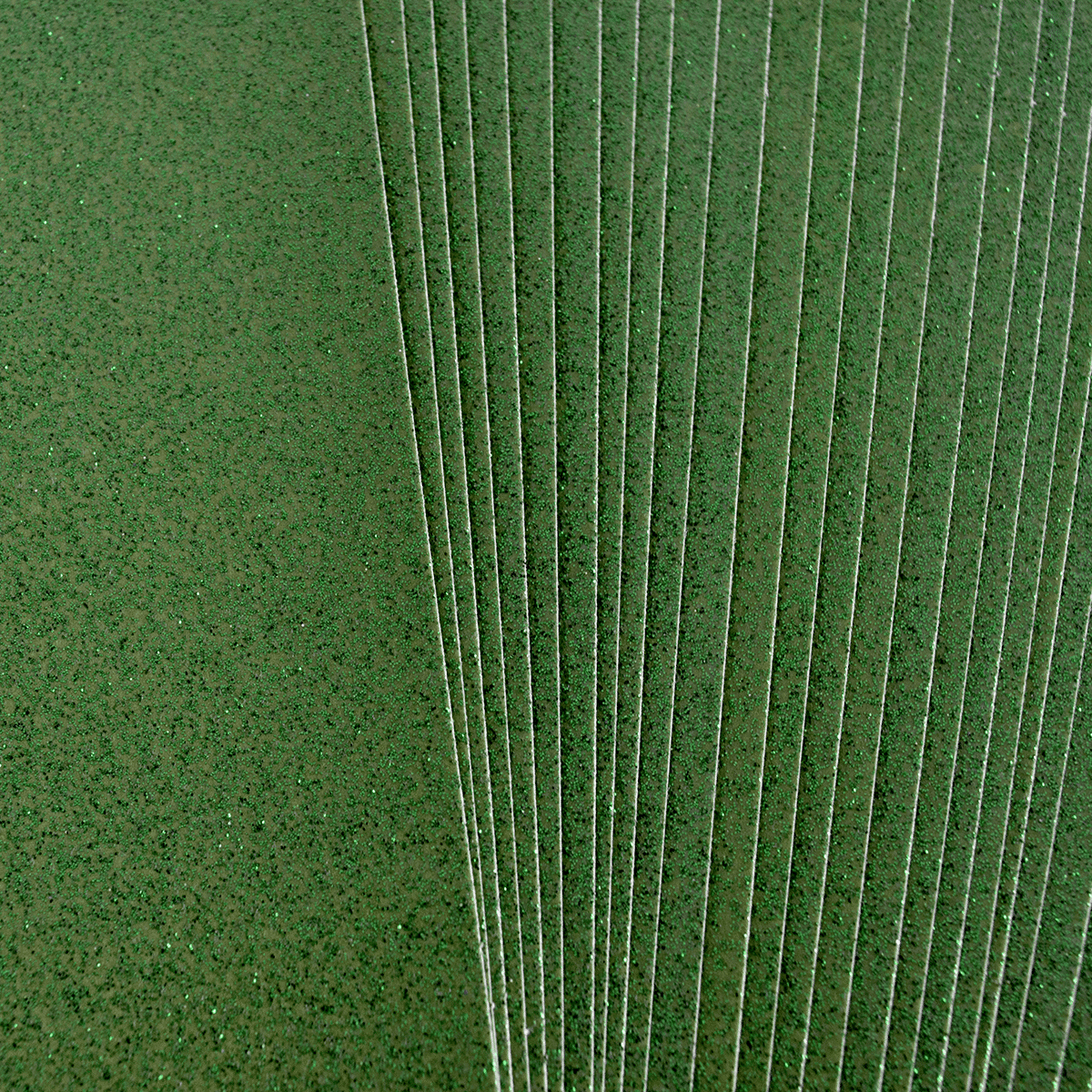 a green field with many lines of sprinkles.