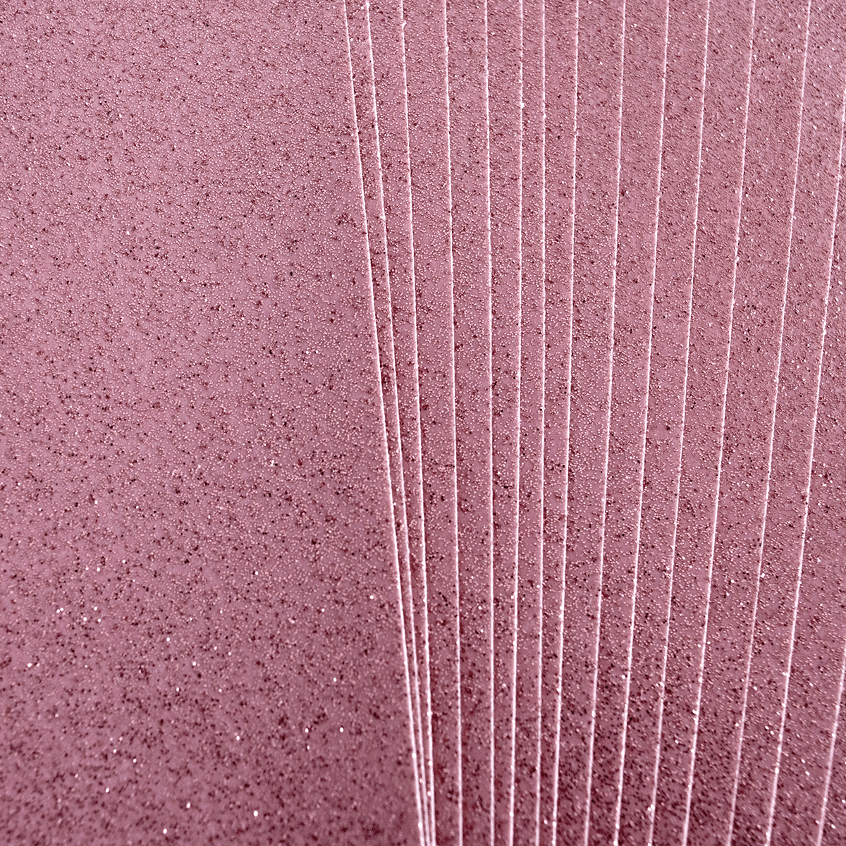 a close up of a pink wall with lots of lines.