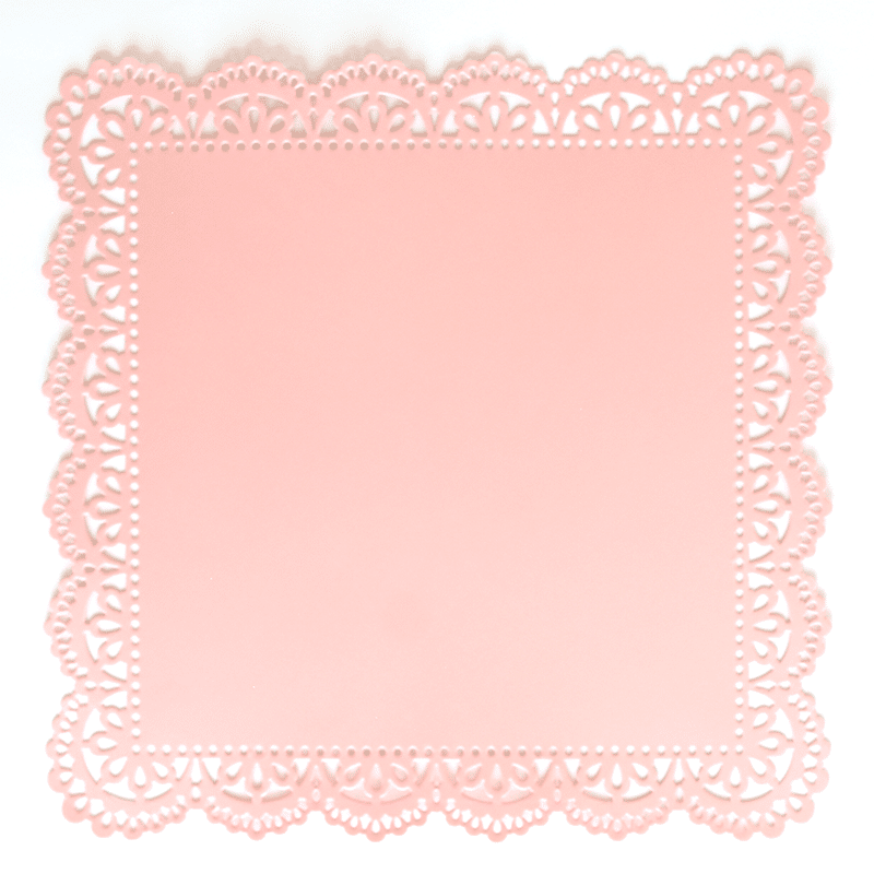 a pink doily with a white background.