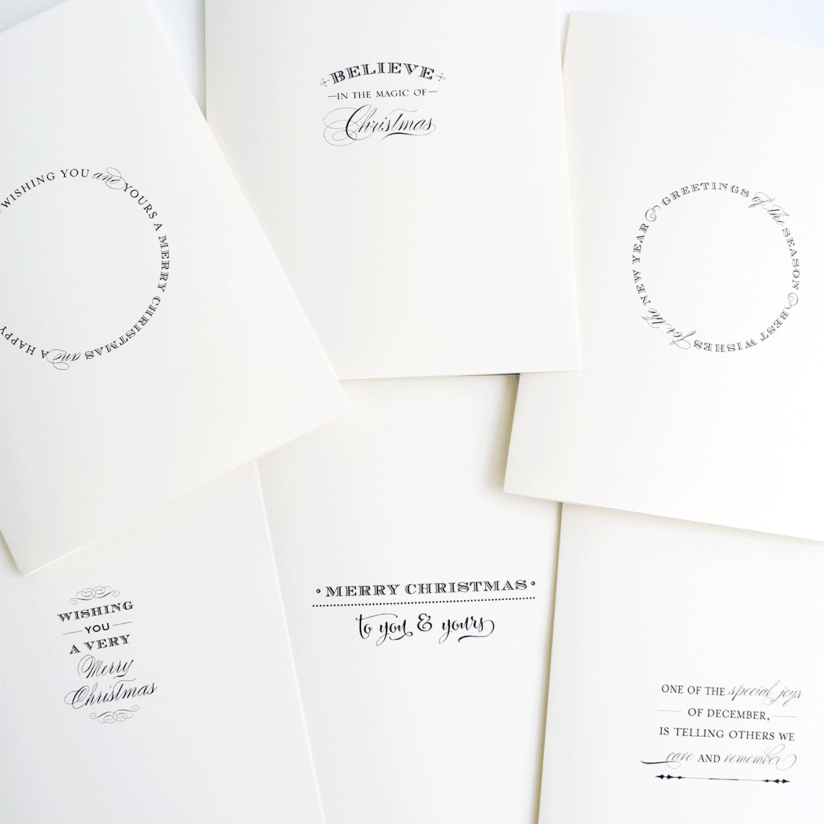 a pile of white cards with black lettering on them.