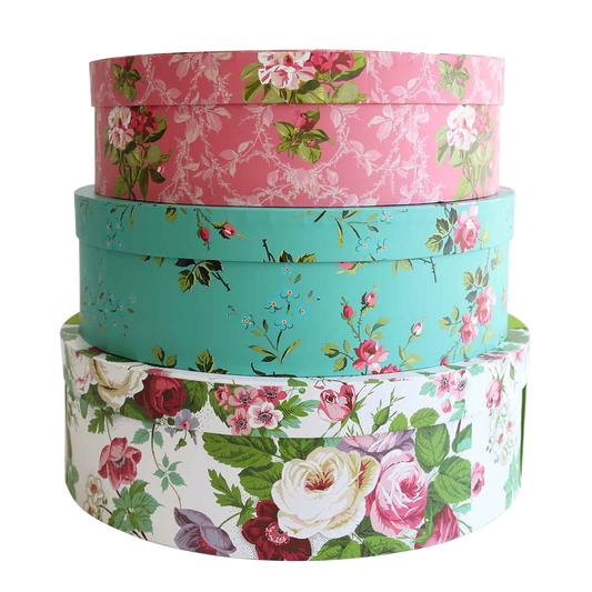 a stack of four flowered boxes sitting on top of each other.
