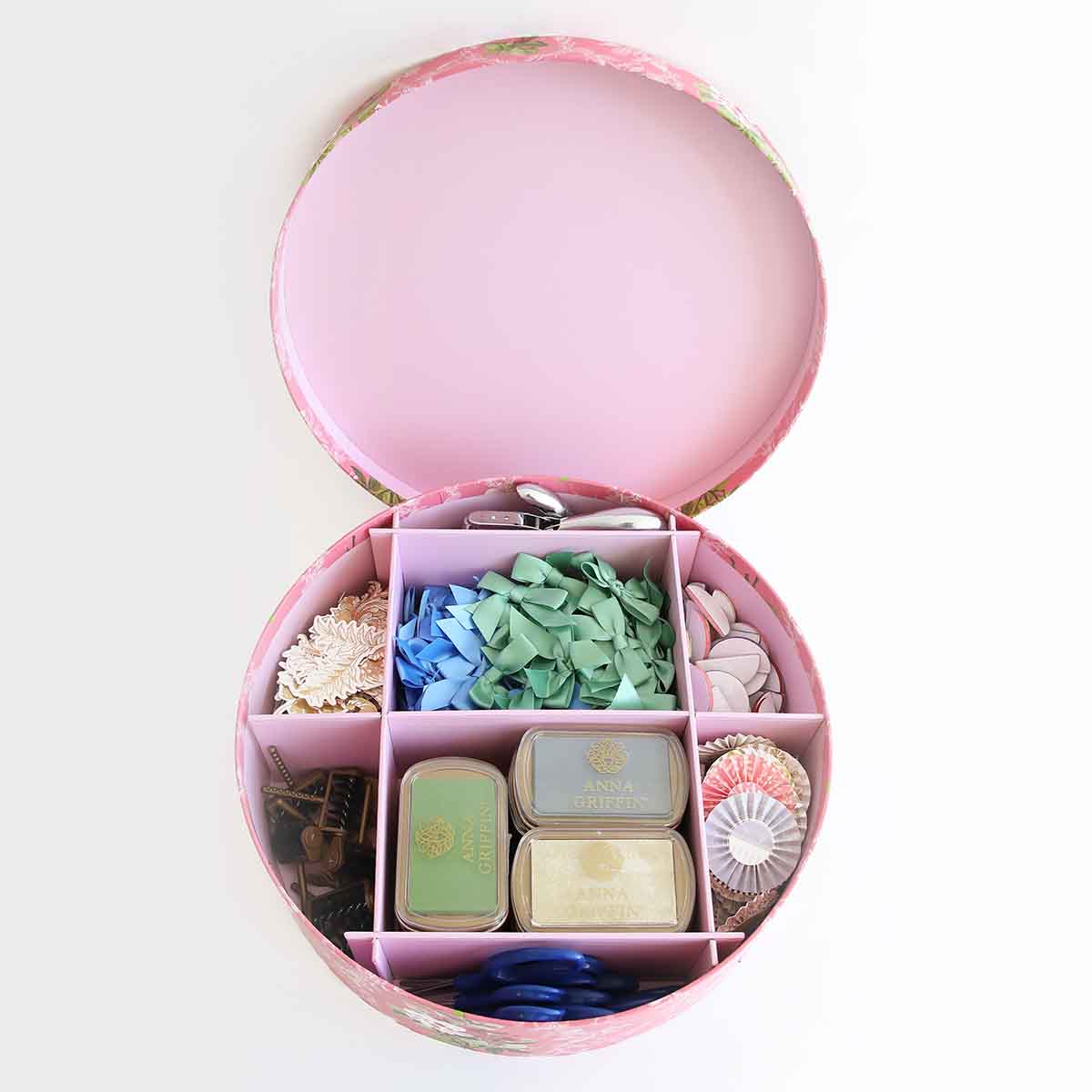 a pink box filled with lots of different items.