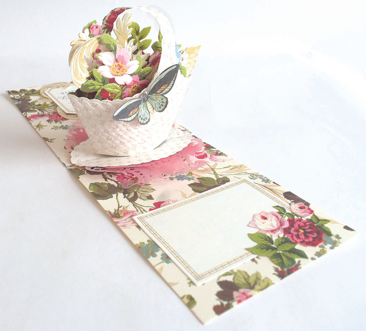 a flower arrangement in a teacup on a table.