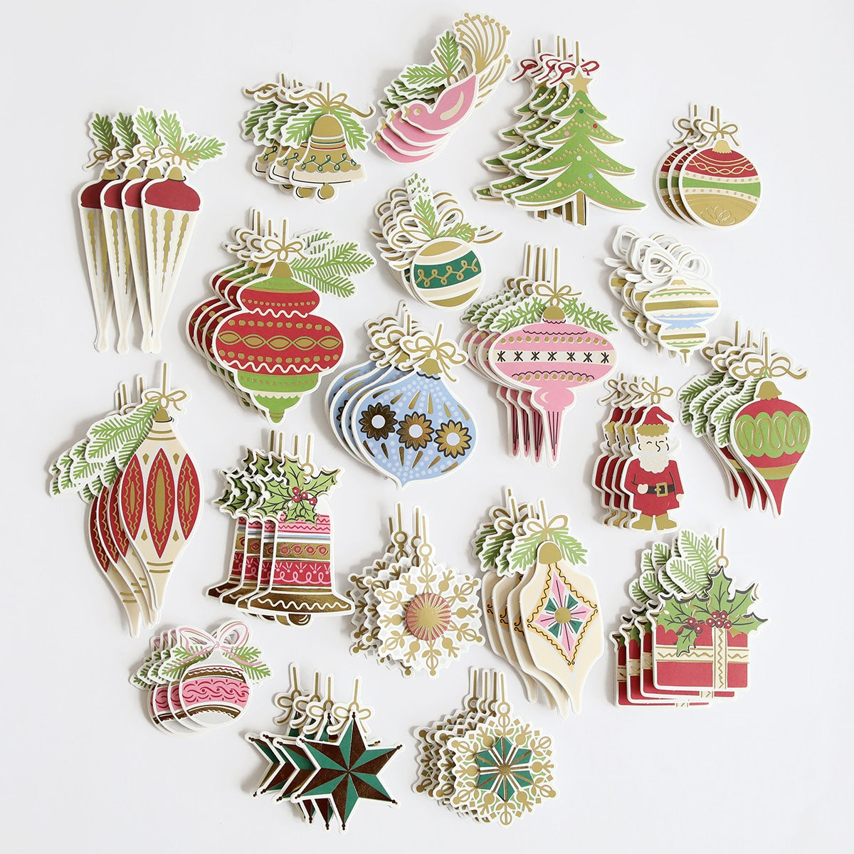 a pile of christmas ornaments on a white surface.