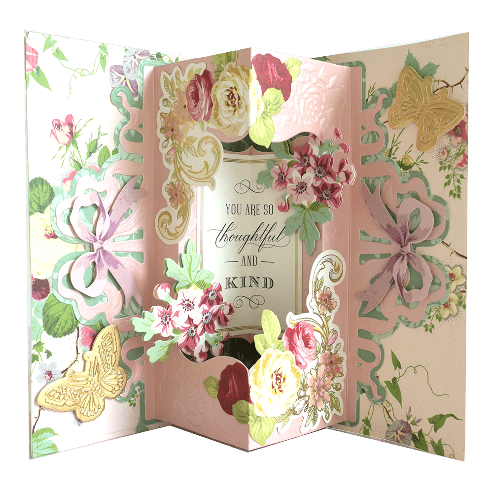 an open card with flowers and butterflies on it.