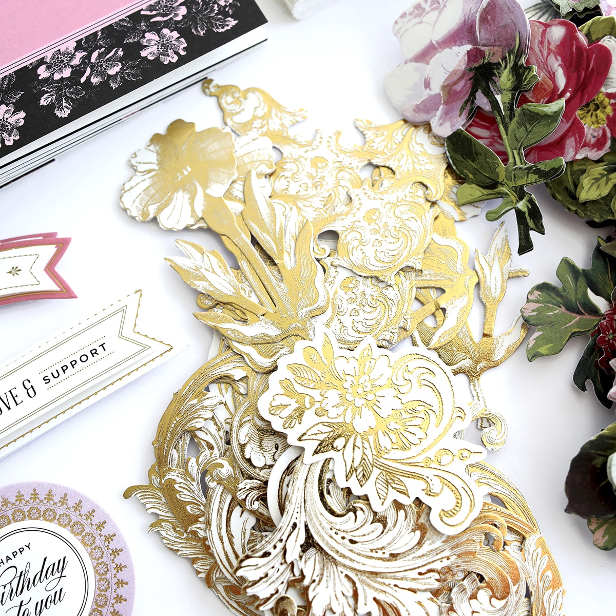 a white table topped with lots of different types of paper.