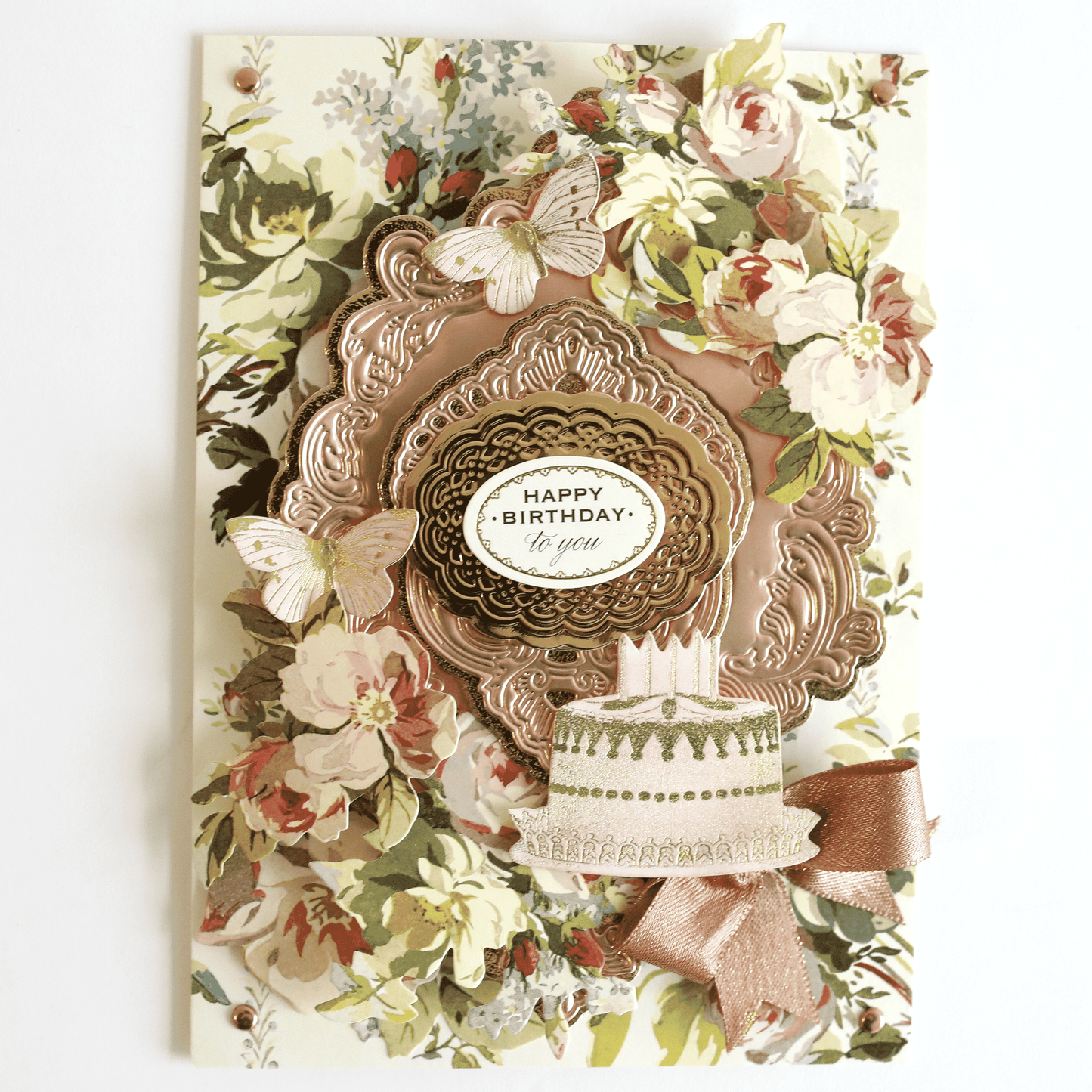 a card with a cake and flowers on it.