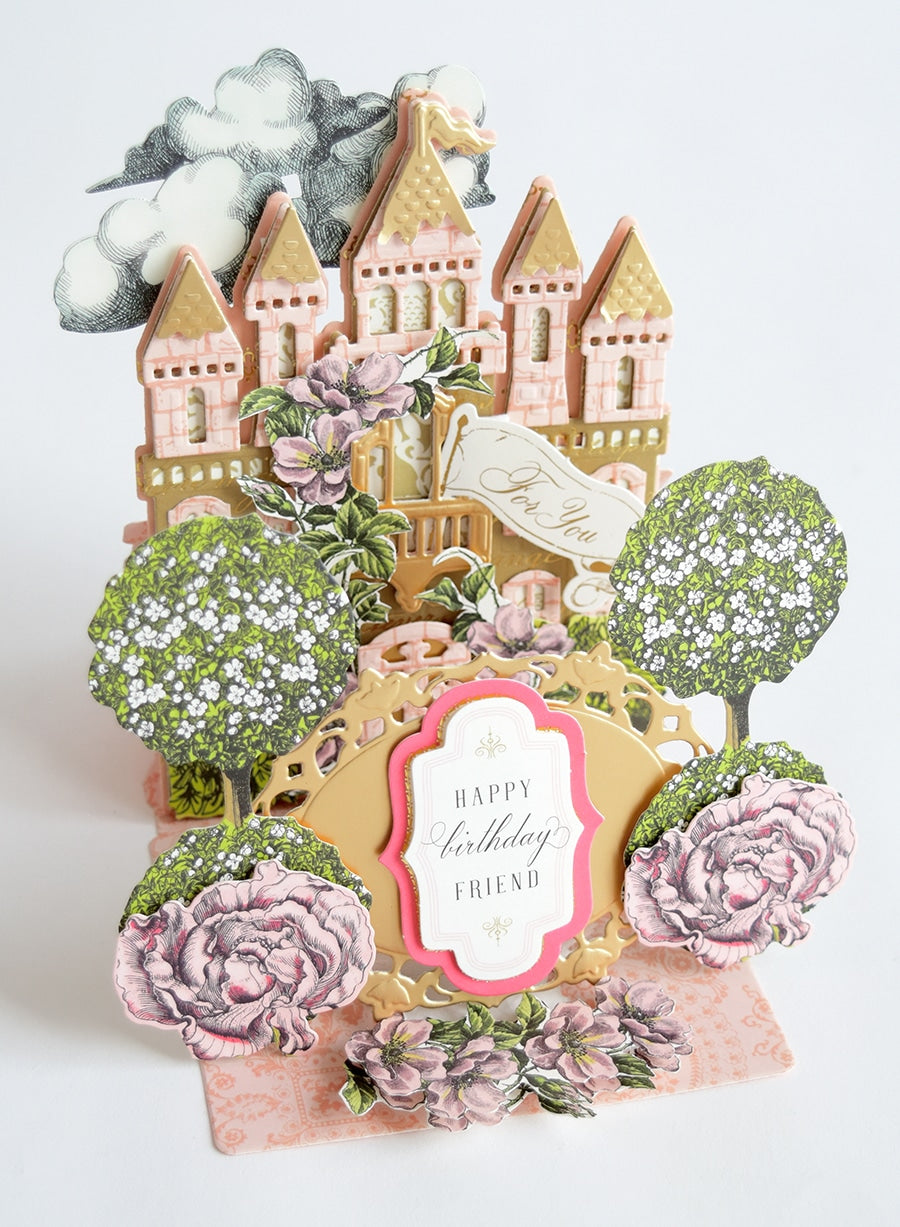 a card with a picture of a castle and flowers.