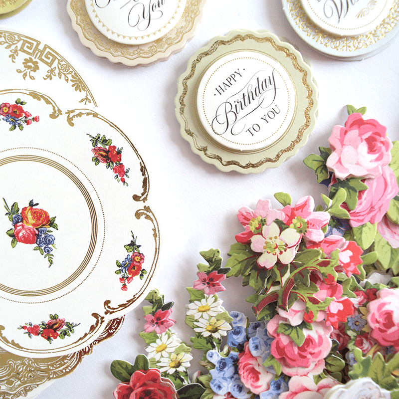 a table topped with plates covered in flowers.