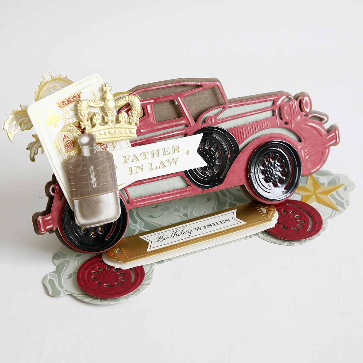 a red Classic Car Slimline Easel Dies with a bottle of cologne.