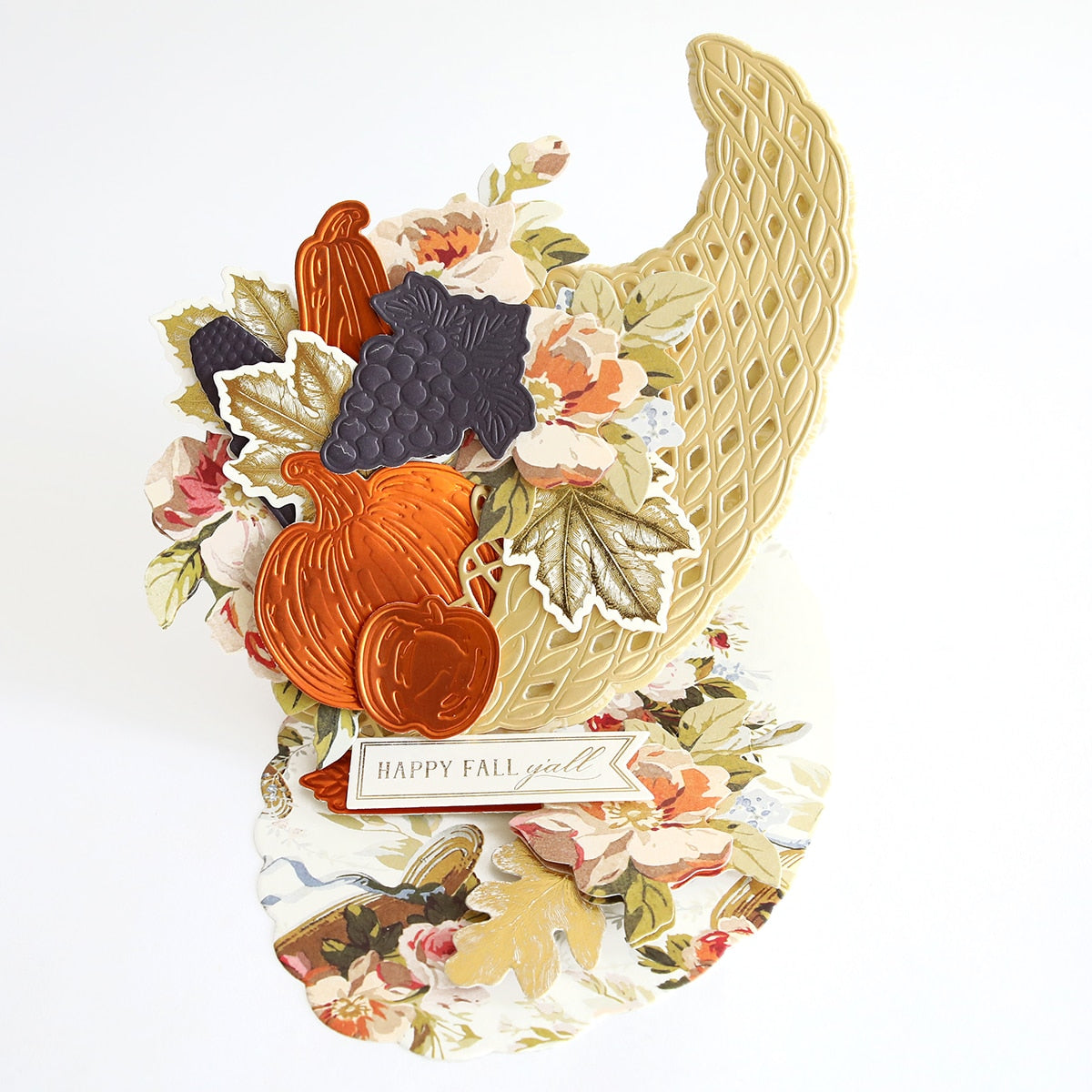 A Cornucopia Easel Card Dies with flowers and leaves on it.