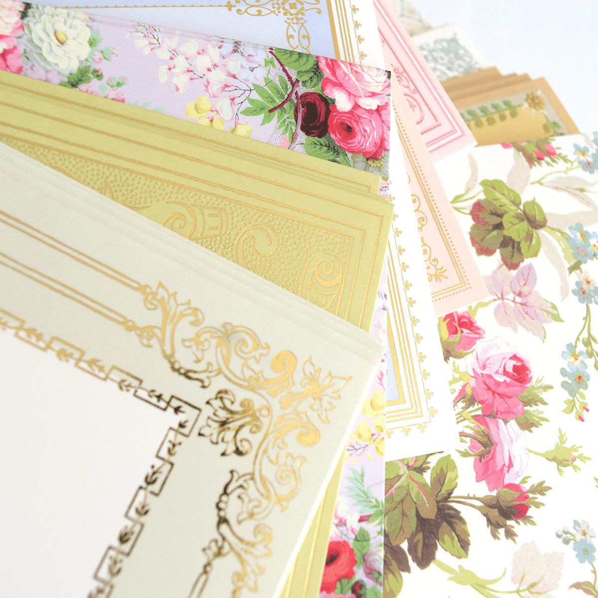 a bunch of papers with flowers on them.