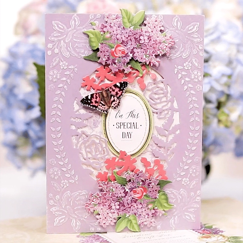 a card with a butterfly and flowers on it.