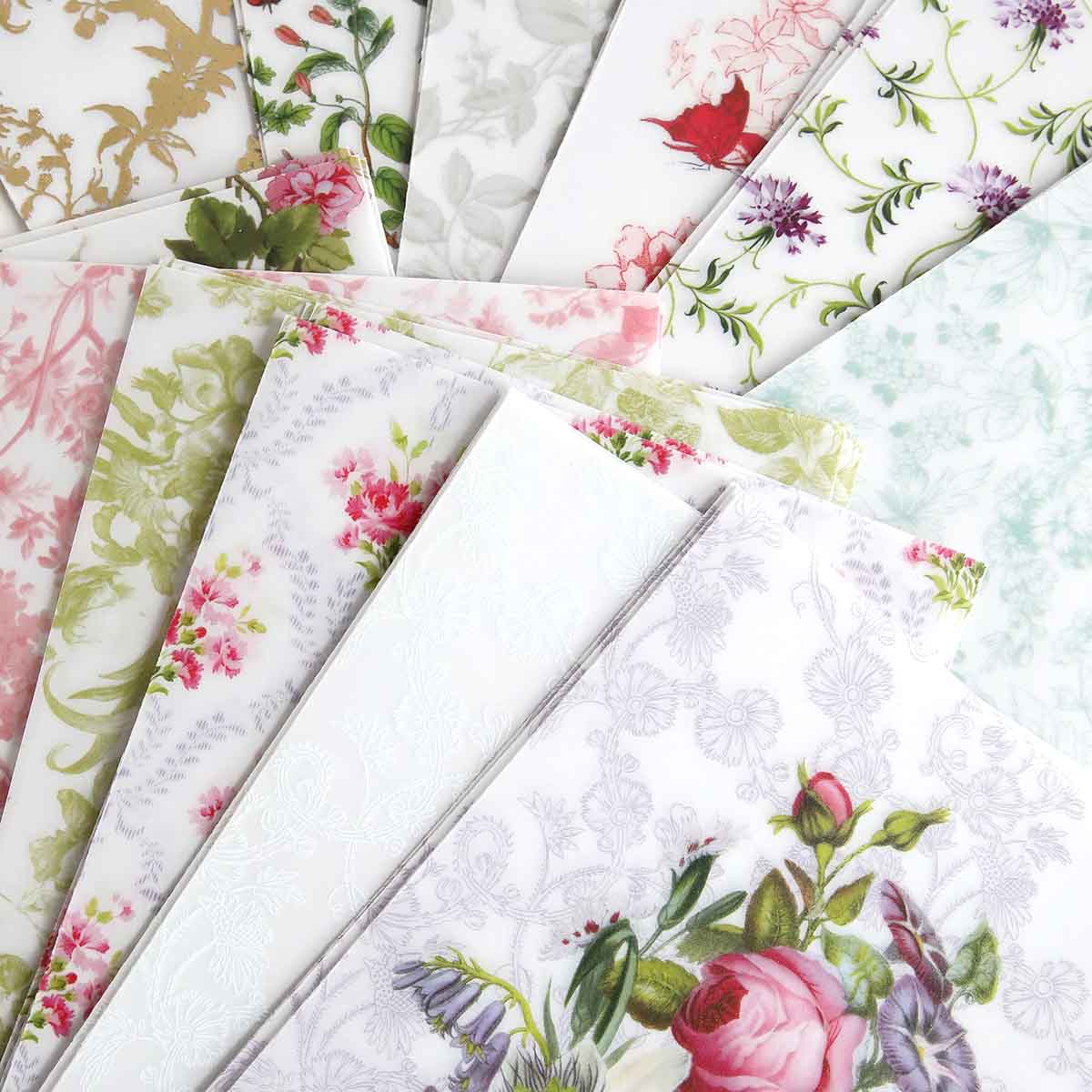 a bunch of different colored papers with flowers on them.
