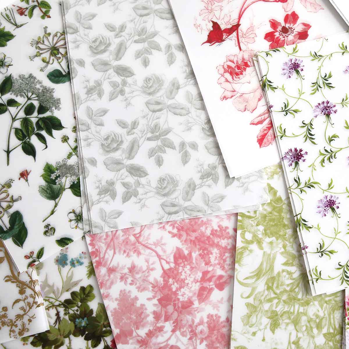 a bunch of different colored papers with flowers on them.