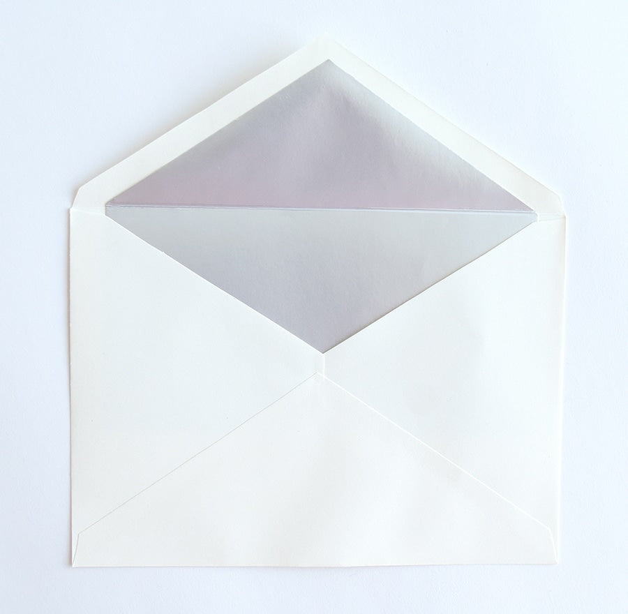 a white envelope with a piece of paper inside of it.