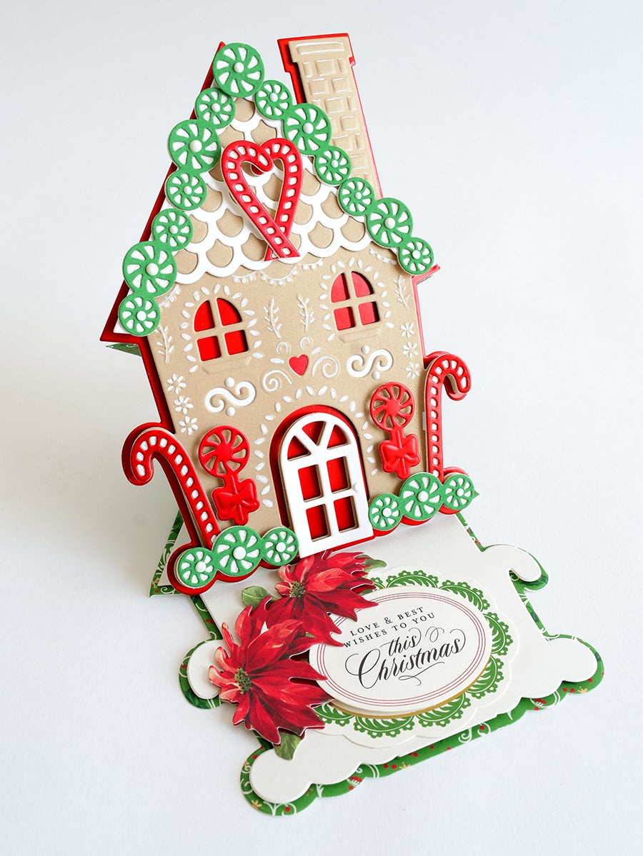 a card with a gingerbread house on it.