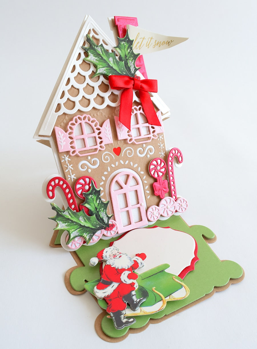 a gingerbread house with a santa clause on it.