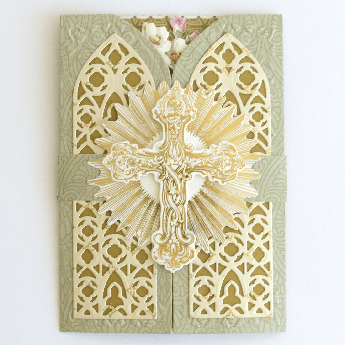 a paper cut of a cross on a wall.