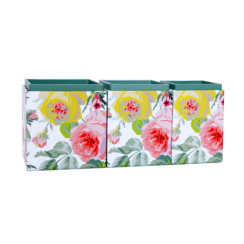 three vases with flowers painted on them.