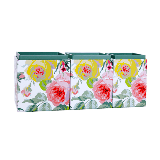 three vases with flowers painted on them.