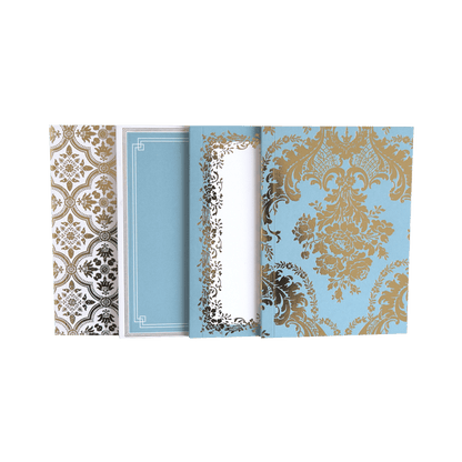 a set of three notebooks sitting on top of each other.