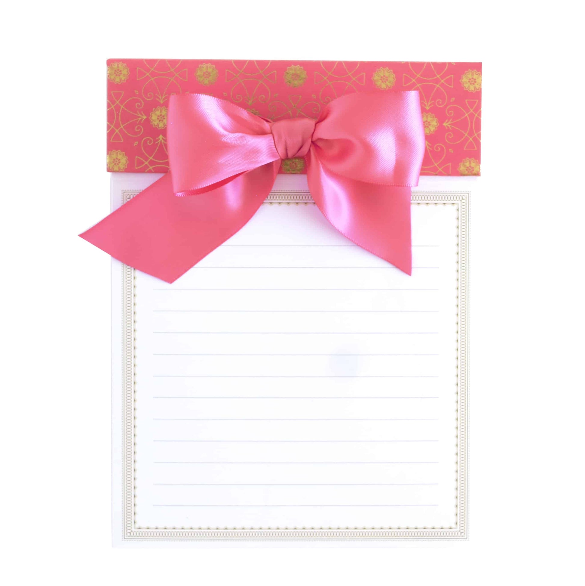 a notepad with a pink bow on top of it.