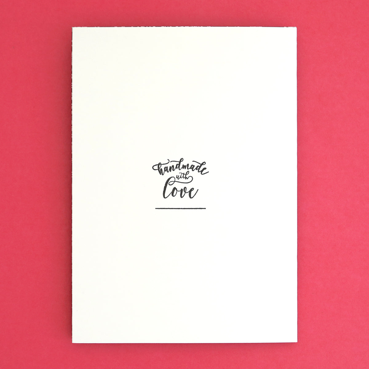 a white notebook with a black handwritten quote on it.