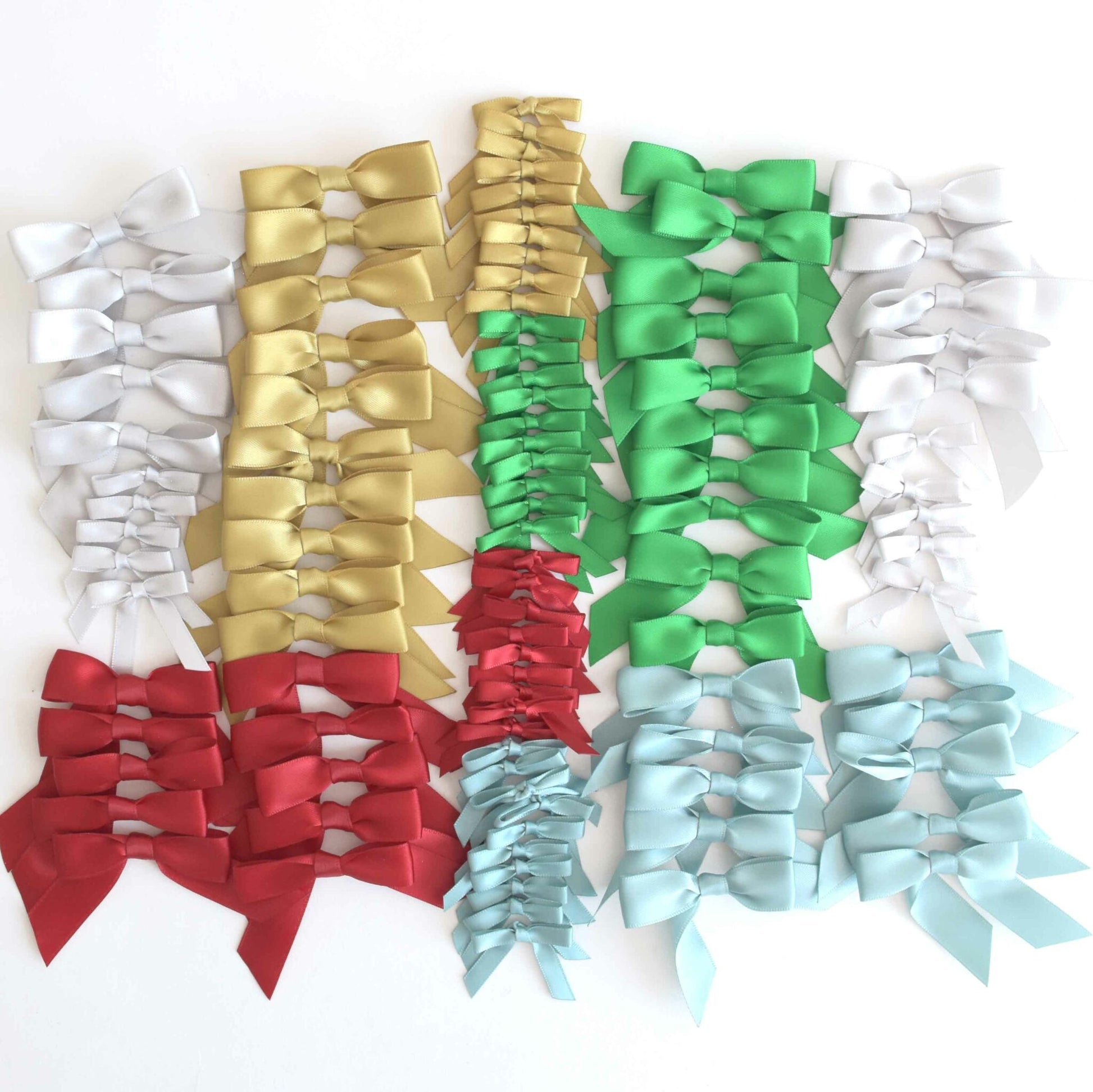 a group of different colored bows on a white background.