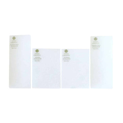 three pieces of white paper on a white background.