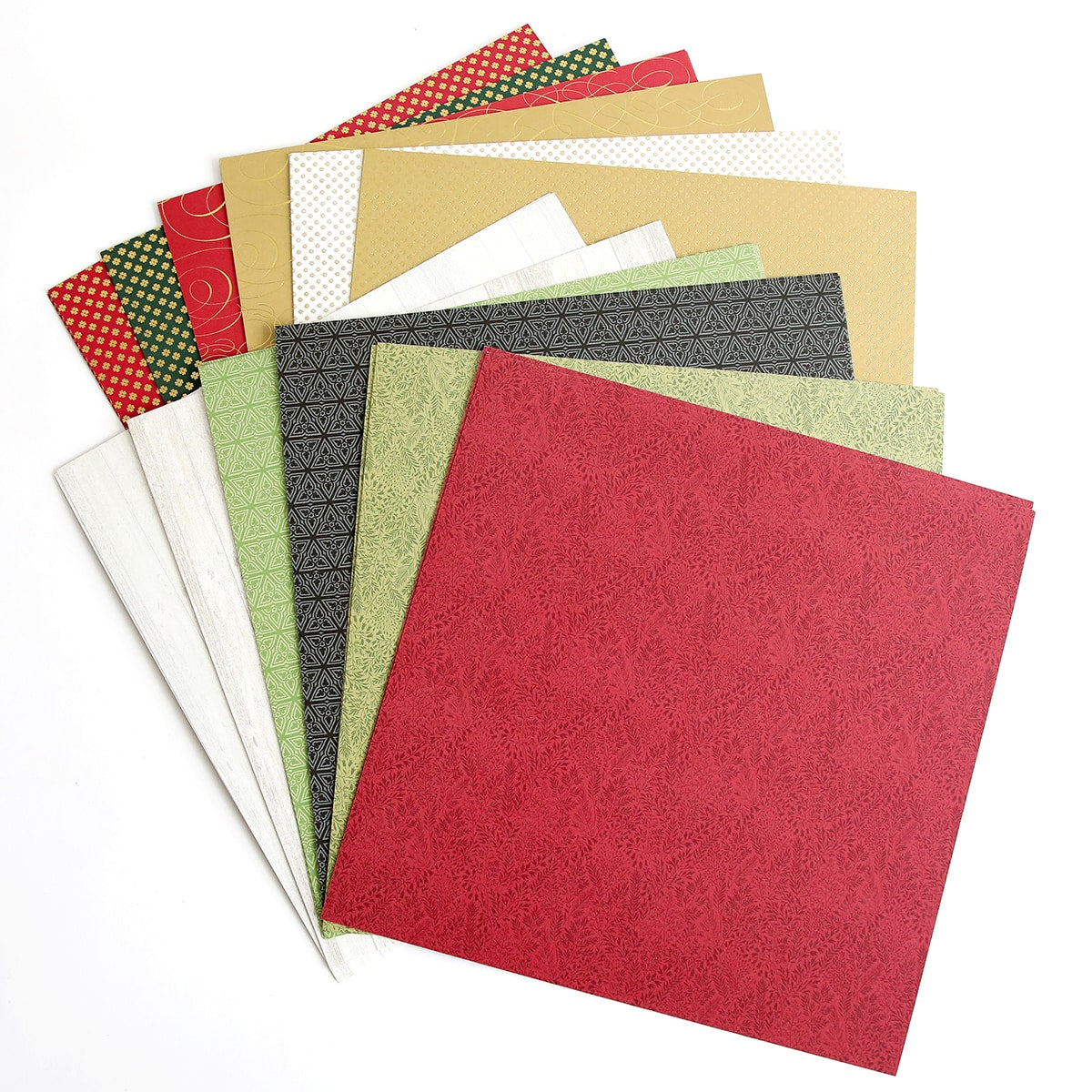 a pile of different colored papers on a white surface.