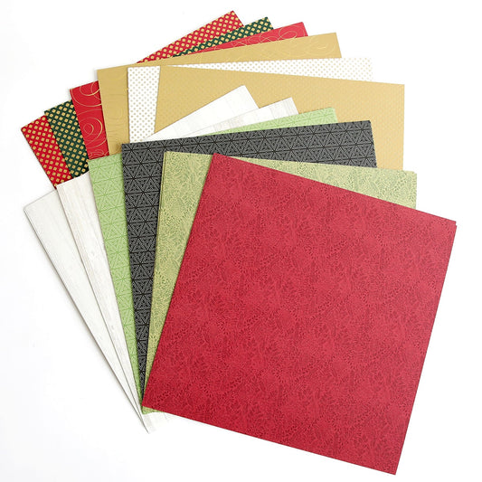 a pile of different colored papers on a white surface.
