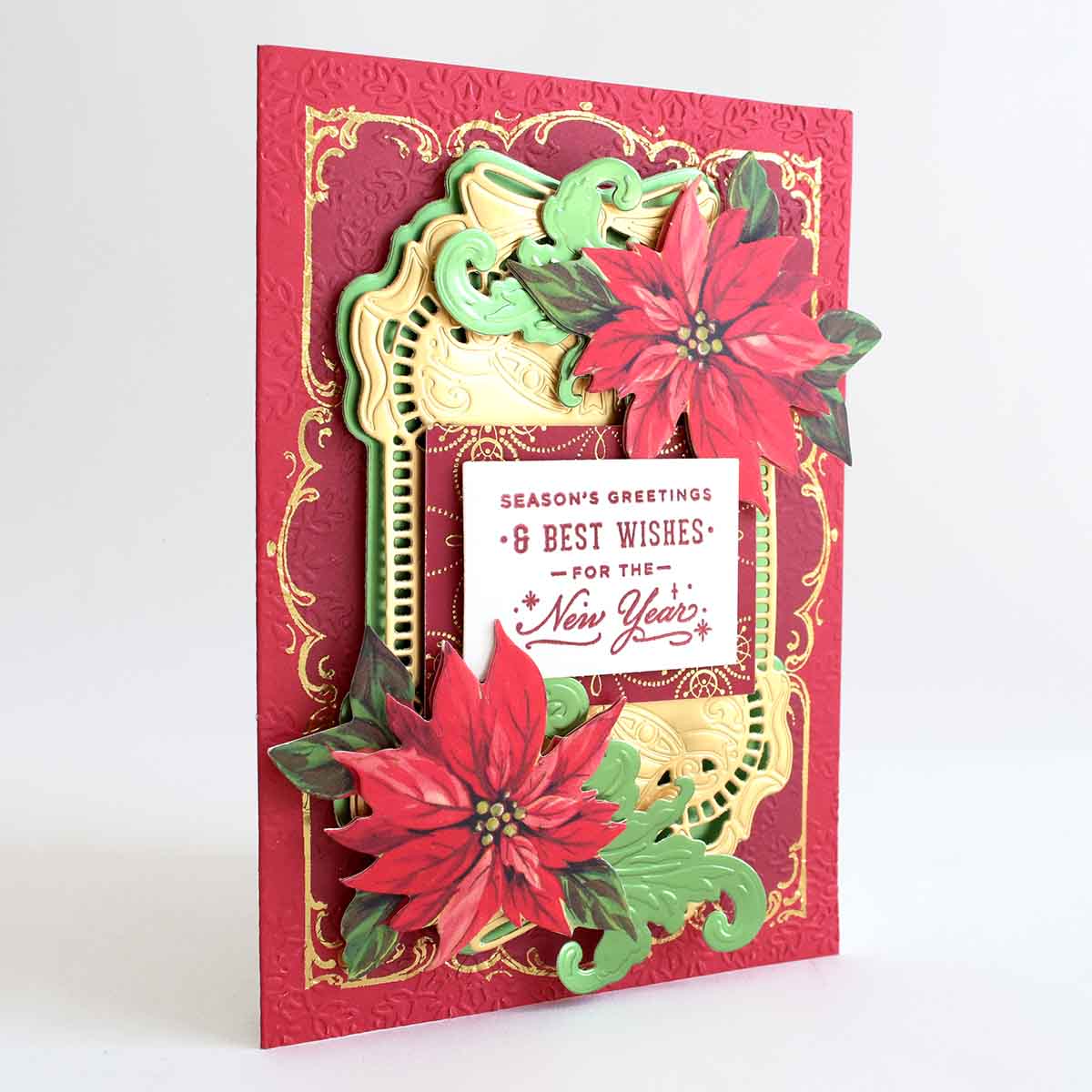 a christmas card with poinsettis on it.