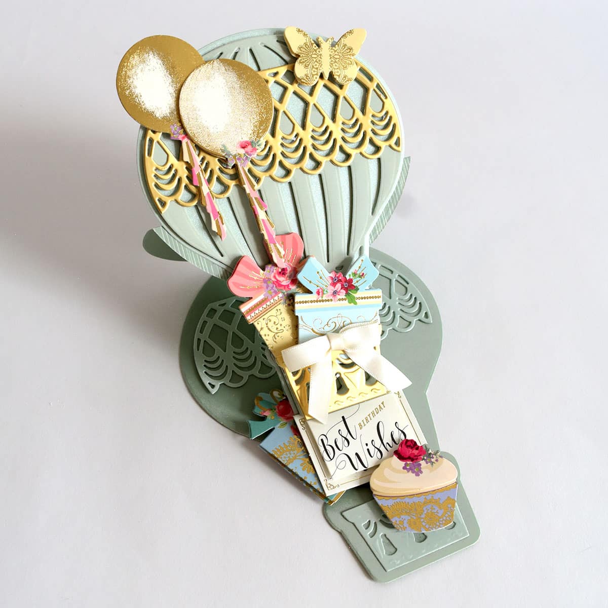a card holder with a gold spoon and a card.