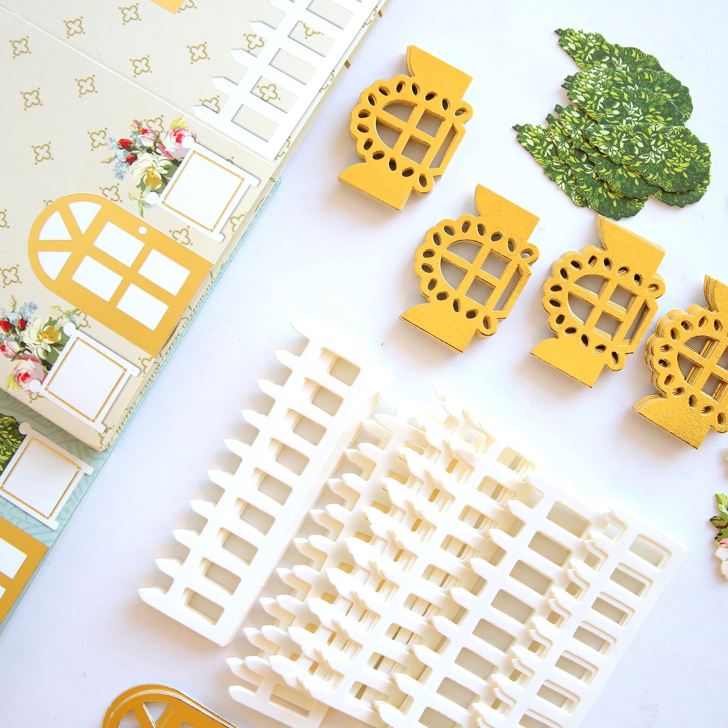 a table topped with yellow and white paper cut outs.