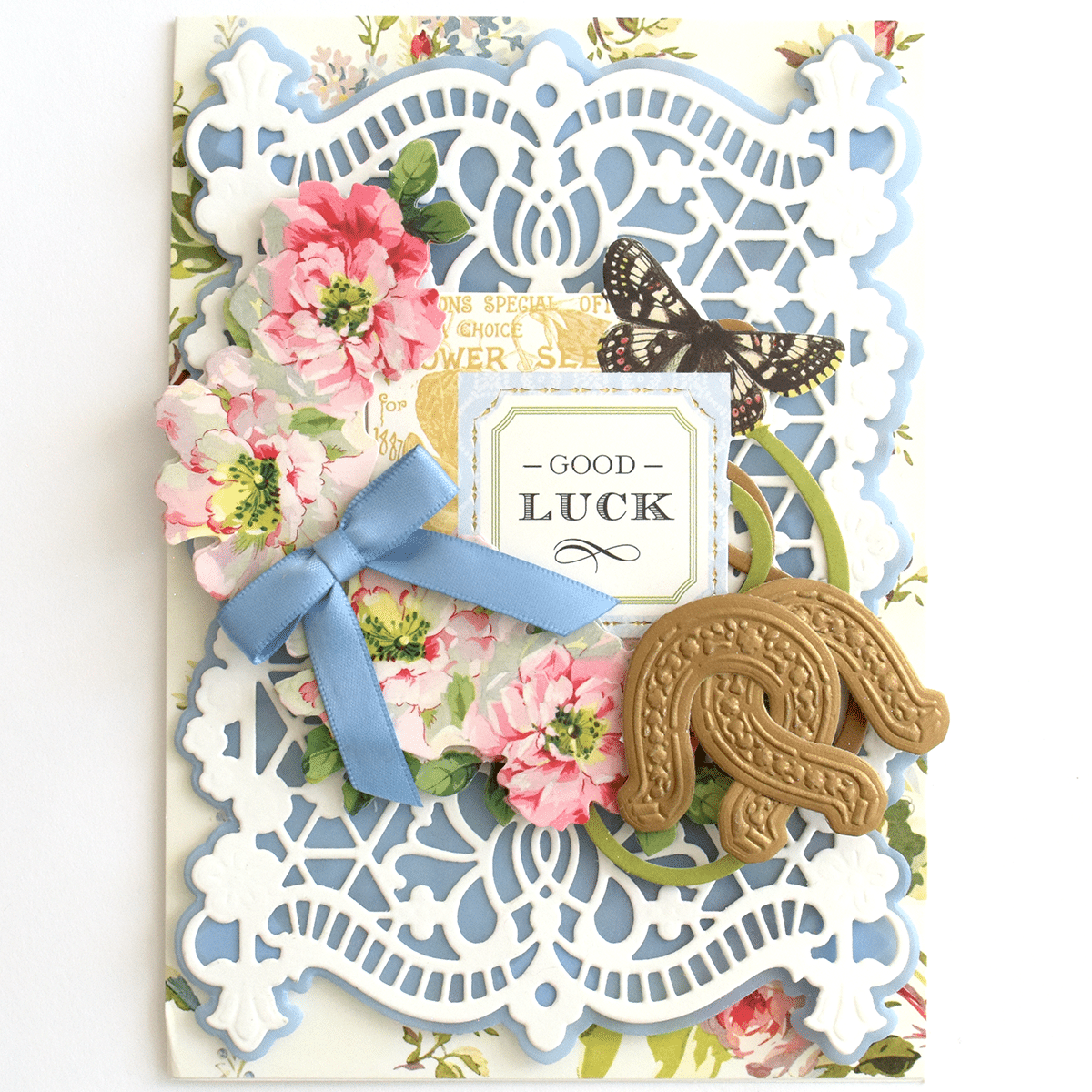 a close up of a card with flowers and a cookie.