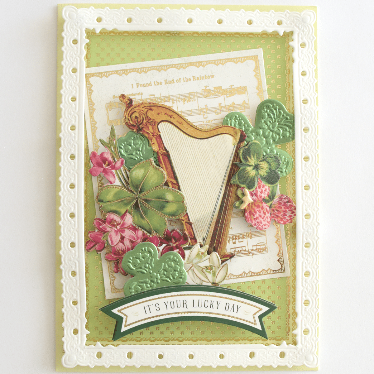 a card with a harp and flowers on it.