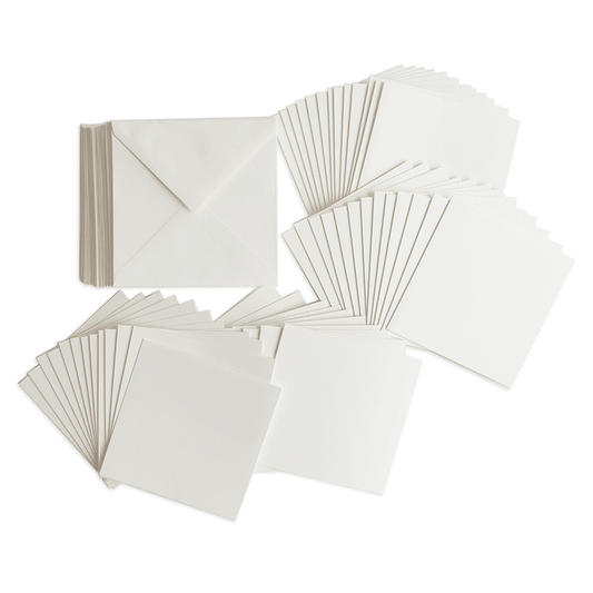 a pile of white cards and envelopes on a green background.