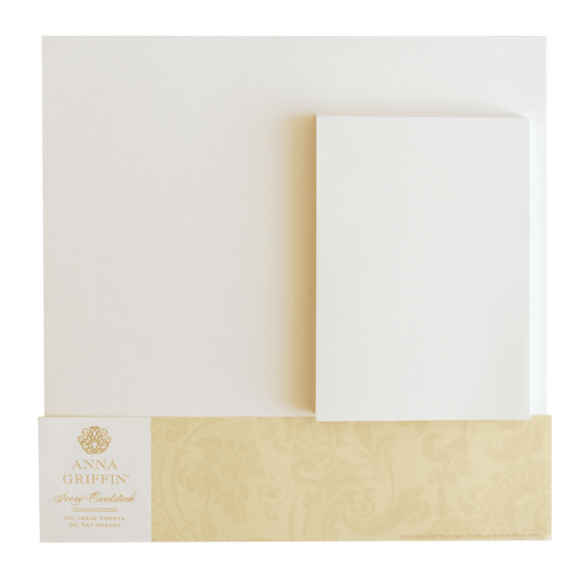 a close up of a white envelope with a gold ribbon.