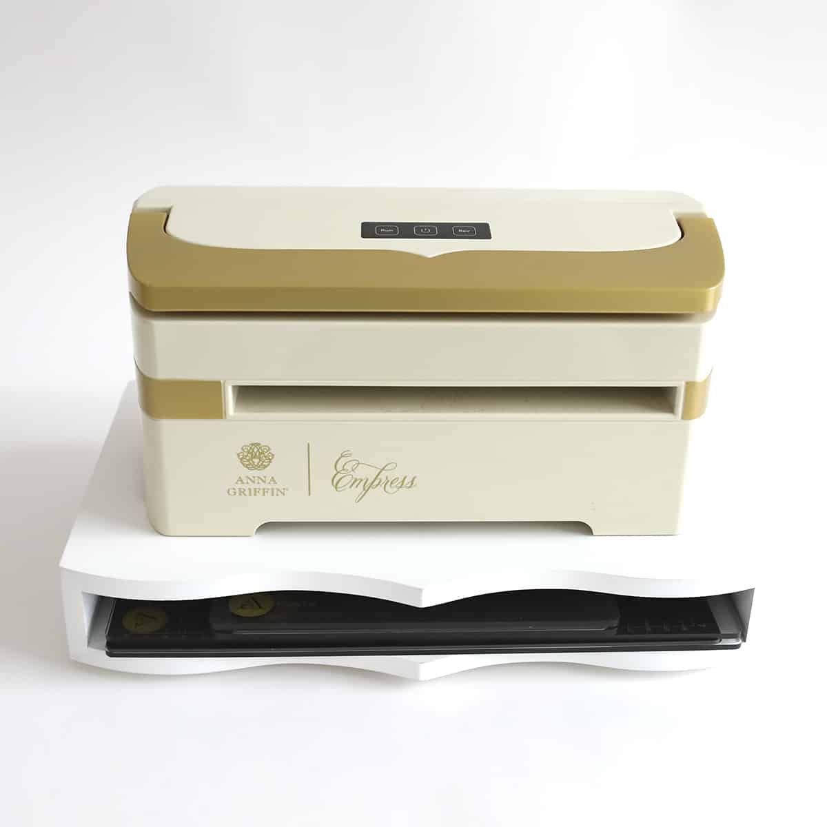 a white and gold box sitting on top of a white table.