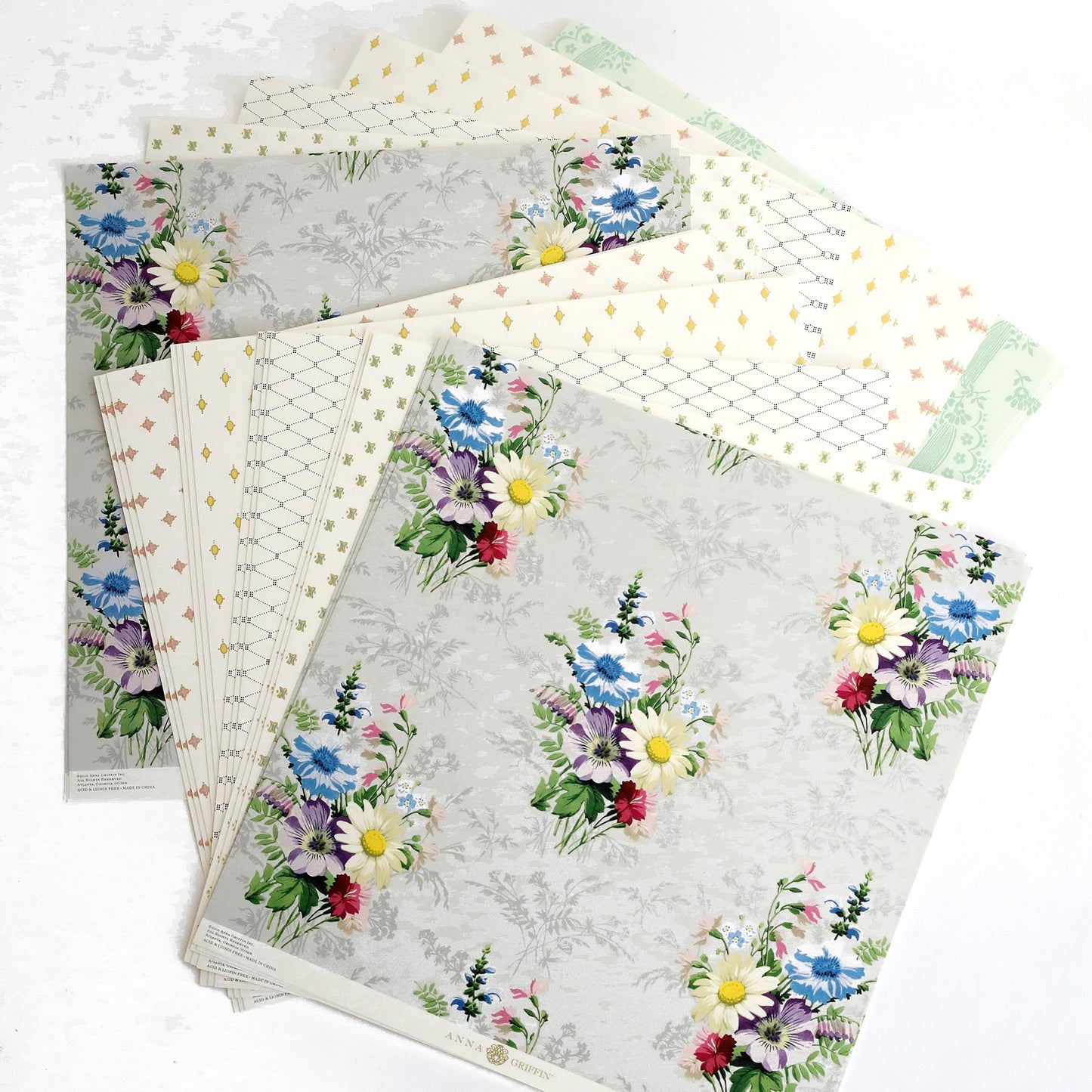 a bunch of papers with flowers on them.