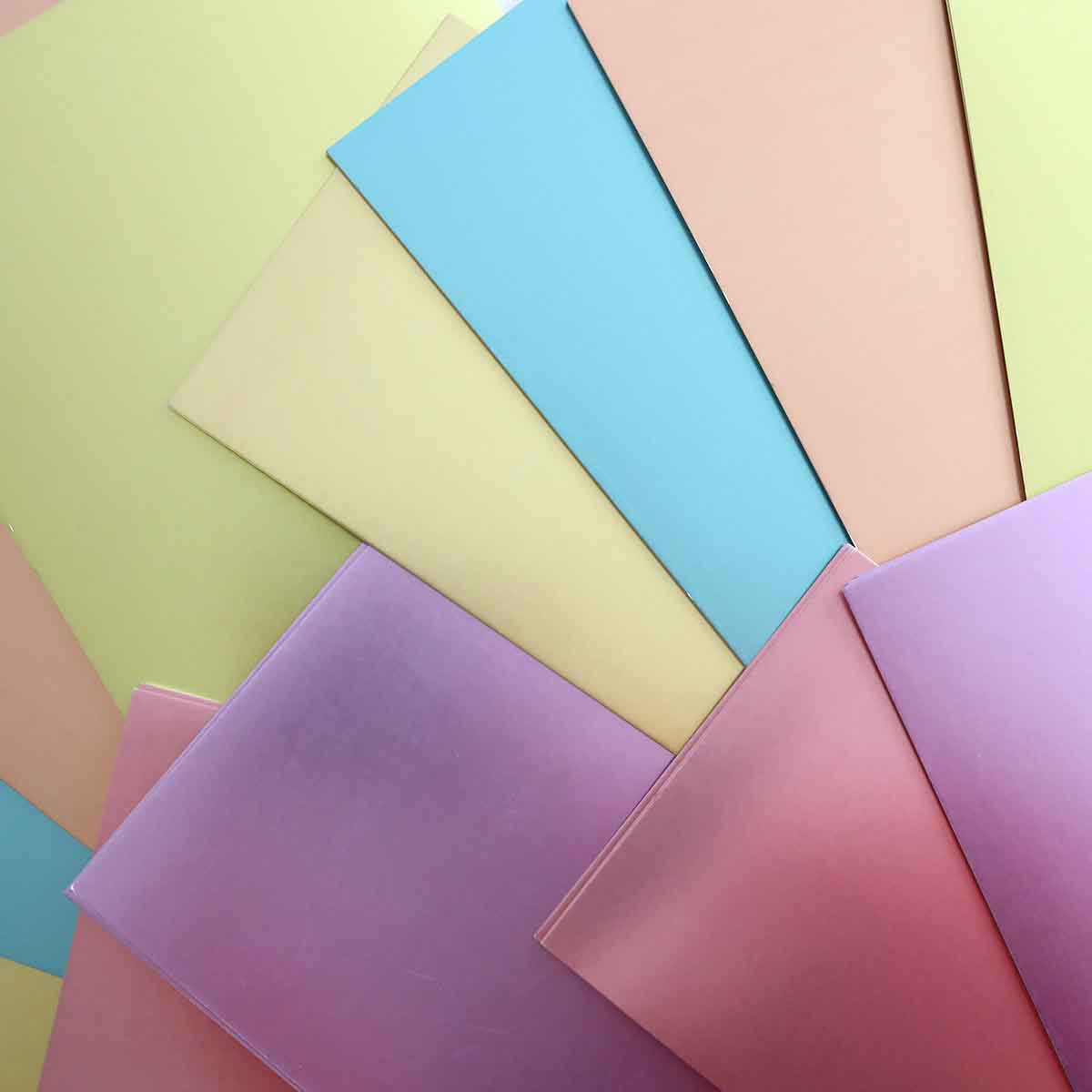 a bunch of different colored papers stacked on top of each other.