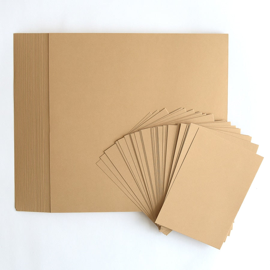 a pile of brown paper sitting on top of a white table.